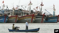 FILE - Vietnamese fishermen paddle their boat in Vung Tau, 125 kilometers (77 miles) southeast of Vietnam's Ho Chi Minh city.