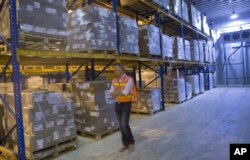 A U.S. service member walks inside a warehouse which will be handed over to the Afghans, in Kandahar Air Base, near Kandahar, Afghanistan, July 25, 2015.