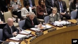 US Secretary of State Hillary Rodham Clinton, right, listens as British Foreign Minister William Hague, left, addresses a Security Council meeting at United Nations headquarters, Monday, March 12, 2012. 