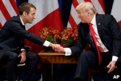 President Donald Trump shakes hands with French President Emmanuel Macron during a meeting at the Palace Hotel, Sept. 18, 2017, in New York.