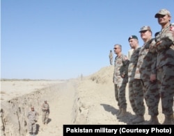 Pakistan army officers survey the trench near the border with Afghanistan.