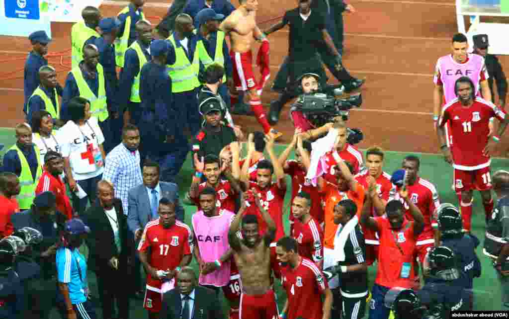 Equatorial Guinea players protected police as they leave the field following a controversial win against Tunisia during the Africa Cup quarterfinals. January 31, 2015.