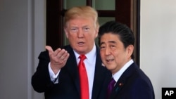 President Donald Trump welcomes Japanese Prime Minister Shinzo Abe to the White House in Washington, June 7, 2018. 