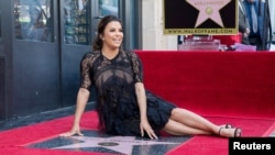 FILE - Eva Longoria poses on the Hollywood Walk of Fame in Los Angeles, California, April 16, 2018.