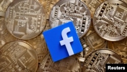 Facebook logo is seen on representations of Bitcoin virtual currency in this illustration picture