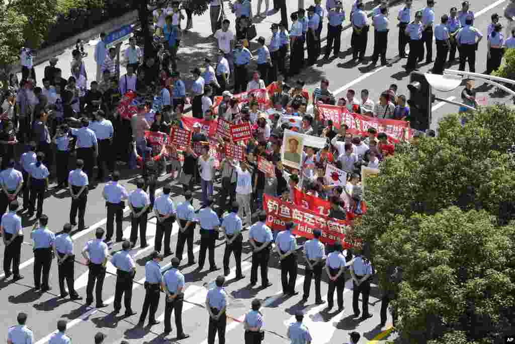 Chinese protesters are stopped near the Japanese Consulate General in Shanghai, China, September 16, 2012.