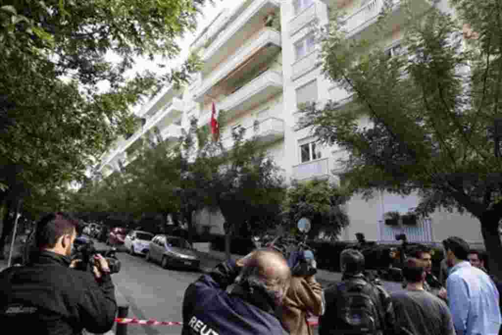 Media stand outside the Swiss Embassy after an explosion in Athens, 02 Nov 2010
