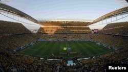 FILE - National soccer players from Brazil (L) and Croatia enter the stadium before their 2014 World Cup opening match at the Corinthians arena in Sao Paulo, June 12, 2014.