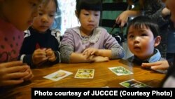 In JUCCCE’s New Way to Eat program, a card game encourages Chinese children to eat a plant-based diet. They’re shown at Sproutworks, a Shanghai salad and sandwich shop. (Photo courtesy of JUCCCE)