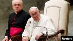 Pope Francis looks on during the weekly general audience in the Paul VI Hall, at the Vatican, Oct. 6, 2021. 