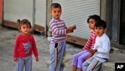 FILE - Syrian refugee children pass time in a neighborhood of the city of Gaziantep, southeastern Turkey on May 16, 2016.