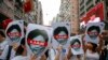 Protesters hold pictures of Hong Kong Chief Executive Carrie Lam as protesters march along a downtown street against the proposed amendments to an extradition law in Hong Kong Sunday, June 9, 2019.19. 