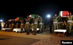 Members of the Kenya Defense Forces carry caskets of their comrades serving in the African Union Mission in Somalia (AMISOM), who were killed during an attack last week on a military base in the west of Somalia near the Kenyan border by Somalia's al-Shabab.