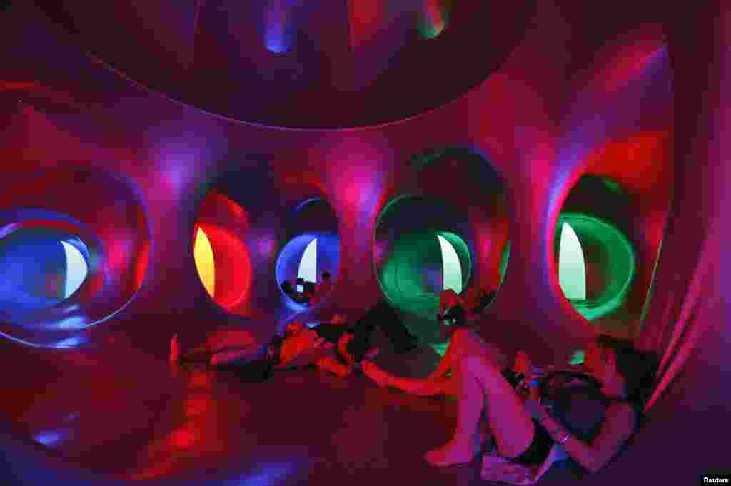 Revelers relax inside a 3-D Luminarium inflatable installation by British designer Alain Parkinson during Budapest's Sziget music festival on an island in the Danube River, Hungary, Aug. 16, 2014.