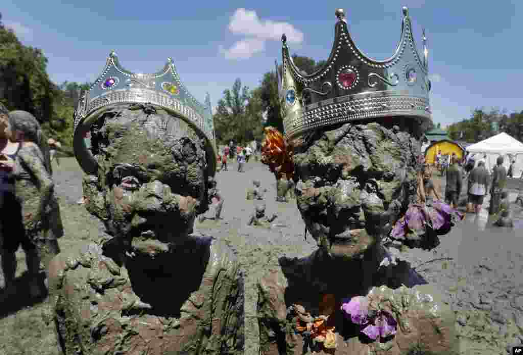 Aiden Haas, left, and Lilli Alcala are crowned Mud King and Mud Queen at the 29th annual Mud Day in Westland, Michigan, July 12, 2016.