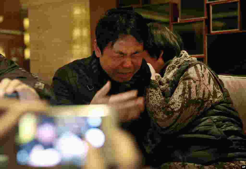 Jiang Hui, left, and Dai Shuqin, relatives of passengers onboard the Malaysia Airlines Flight 370 that went missing on Mar. 8, 2014, react while watching a pre-recorded message broadcast on Malaysian television by Malaysia&#39;s Civil Aviation Authority, in Beijing, China. Malaysia&#39;s Civil Aviation Authority has officially declared the MH370 crash an accident, fulfilling a legal obligation that will allow efforts to proceed with compensation claims. &nbsp;