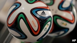 The adidas logo is printed on "Brazuca", the official FIFA World Cup 2014 soccer ball, during the annual shareholders meeting in Fuerth, Germany, May 8, 2014.
