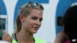 Russia's long jumper Darya Klishina speaks at the National track and field championships at a stadium in Cheboksary, Russia, Monday, June 20, 2016. 