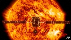 This illustration made available by NASA depicts the Solar Orbiter satellite in front of the Sun. European Space Agency have planned to launch the spacecraft on a mission to the sun to get close-up views of its polar regions. ESA/ATG medialab, NASA/SDO