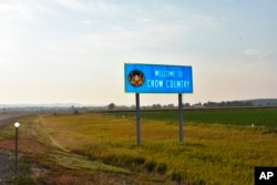 FILE - In this Aug. 26, 2020, photo, a sign marking the boundary of the Crow Indian Reservation stands near Hardin, Montana. The reservation shrank from 38 million acres in 1851 to its present size of 2.2 million acres.