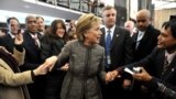 State Department employees welcome Hillary Clinton to the State Department building in Washington, January 22, 2009. 