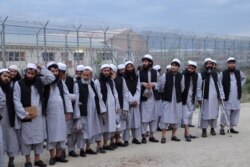 FILE - Newly freed Taliban prisoners line up at Bagram prison, north of Kabul, Afghanistan, April 11, 2020, in this photo provided by the National Security Council of Afghanistan.