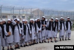 Newly freed Taliban prisoners line up at Bagram prison, north of Kabul, Afghanistan, April 11, 2020, in this photo provided by National Security Council of Afghanistan.
