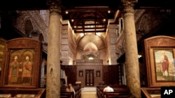 A man and woman pray at the Cavern Church, and the martyrs Sergius and Bacchus, famously known as the Abu Serga Church, in Old Cairo, Egypt, Aug. 30, 2016. Many of Egypt's Christians are infuriated by passage of a law giving authorities broad powers to veto church construction.