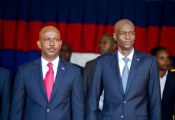 Haiti's President Jovenel Moise, right, stands with resigning prime minister Jean Michel Lapin, at the national palace during a ceremony marking the 216th anniversary of the Battle of Vertieres in Port-au-Prince, Haiti, Nov. 18, 2019.