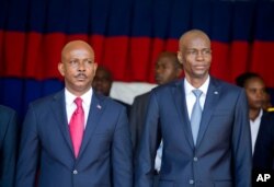 Haiti's President Jovenel Moise, right, stands with resigning prime minister Jean Michel Lapin, at the national palace during a ceremony marking the 216th anniversary of the Battle of Vertieres in Port-au-Prince, Haiti, Nov. 18, 2019.