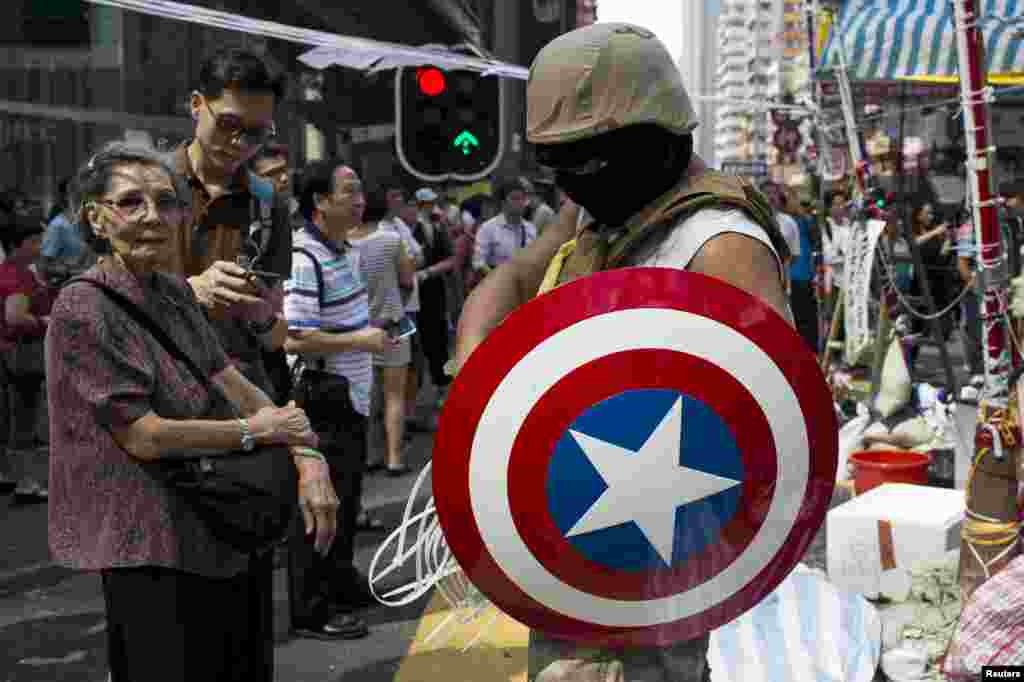 A protester of the Occupy Central movement carries a 'Captain America' shield at the Mong Kok shopping district in Hong Kong, Oct. 6, 2014.