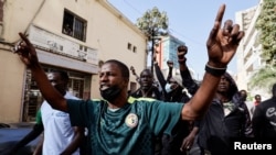 FILE - Senegalese demonstrators shout slogans after they were pushed back by riot police while they to tried to gather to protest the postponement of the February 25 presidential election, near Senegal's National Assembly in Dakar, Senegal February 5, 2024.