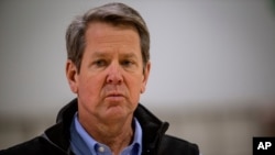 FILE - Georgia Gov. Brian Kemp listens to a reporter's question at the Georgia World Congress Center on April 16, 2020, in Atlanta.