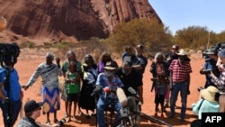 FILE - Australian Aboriginals speak to members of the media at Uluru-Kata Tjuta National Park in Australia's Northern Territory, Oct. 26, 2019.