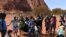 FILE - Australian Aboriginals speak to members of the media at Uluru-Kata Tjuta National Park in Australia's Northern Territory, Oct. 26, 2019.