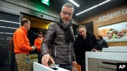 Un cliente escanea la aplicación Amazon Go en su teléfono a la entrada de la primera tienda del gigante en línea que no utiliza cajeros. Seattle, Washington, enero 22 de 2018.