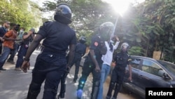 Riot police officers detain a protester who was gathering with others to protest the postponement of the presidential election, near Senegal's National Assembly in Dakar, Senegal Feb. 5, 2024.