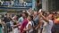 FILE - A New York police officer stands watch as visitors stage selfies for a giant monitor playback in Times Square in New York City, July 3, 2015.