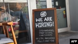 FILE - A 'we are hiring sign' in front of the Buya restaurant in Miami, Florida, March 05, 2021. (Photo by Joe Raedle / Getty Images North America / AFP)