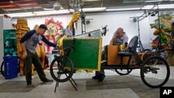 Ryan Ballard, left, founder of the Krewe of Chewbacchus Mardi Gras parade, works on a float with Keith Greene, King of Chewbacchus 2016, at their headquarters at the Castillo Blanco Art Studios in New Orleans, Jan. 2, 2016. 