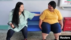 FILE - Patients chat with each other at a weight loss centre in Changchun, Jilin province in northeastern China, June 20, 2010.