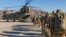 FILE - Soldiers attached to the 101st Resolute Support Sustainment Brigade, Iowa National Guard and 10th Mountain, 2-14 Infantry Battalion load onto a Chinook helicopter to head out on a mission in Afghanistan, Jan. 15, 2019.