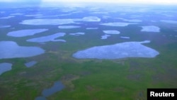 FILE - An aerial view shows lakes in northeast Siberia, Aug. 28, 2007. A new study suggests that the heightened melting of Arctic permafrost could release as much as 40 billion tons of carbon into the atmosphere.