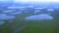 FILE - An aerial view shows lakes in northeast Siberia, Aug. 28, 2007. A new study suggests that the heightened melting of Arctic permafrost could release as much as 40 billion tons of carbon into the atmosphere.