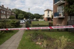 Police cordon tape is seen at the scene of a fatal shooting at Exeter House in Feltham, London