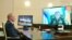 File- Russian President Vladimir Putin listens to General Staff chief Valery Gerasimov, on the screen, during a video conference reporting a successful test launch of the new Zircon hypersonic cruise missile, Oct. 7, 2020.