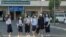 A group of students walks to school on the first day of a new academic year, in Phnom Penh Cambodia, January 11, 2021. (Tum Malis/VOA Khmer)