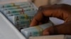 FILE - An electoral official checks permanent voters cards at a distribution center in Lagos, ahead of Feb. 2023 Presidential elections in Lagos, Nigeria, Wednesday, Jan. 11, 2023