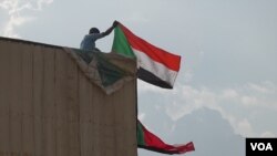 Sudanese pro-democracy supporters celebrate a final power-sharing pact with the ruling military council, Aug 17, 2019, in Khartoum. The deal paves the way for a transition to civilian-led government following the overthrow of President Omar al-Bashir.