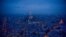 This general view taken from the rooftop of The Tour Montparnasse at twilight on January 8, 2018, shows The Eiffel Tower (C) and The Dome des Invalides (R) in Paris.
